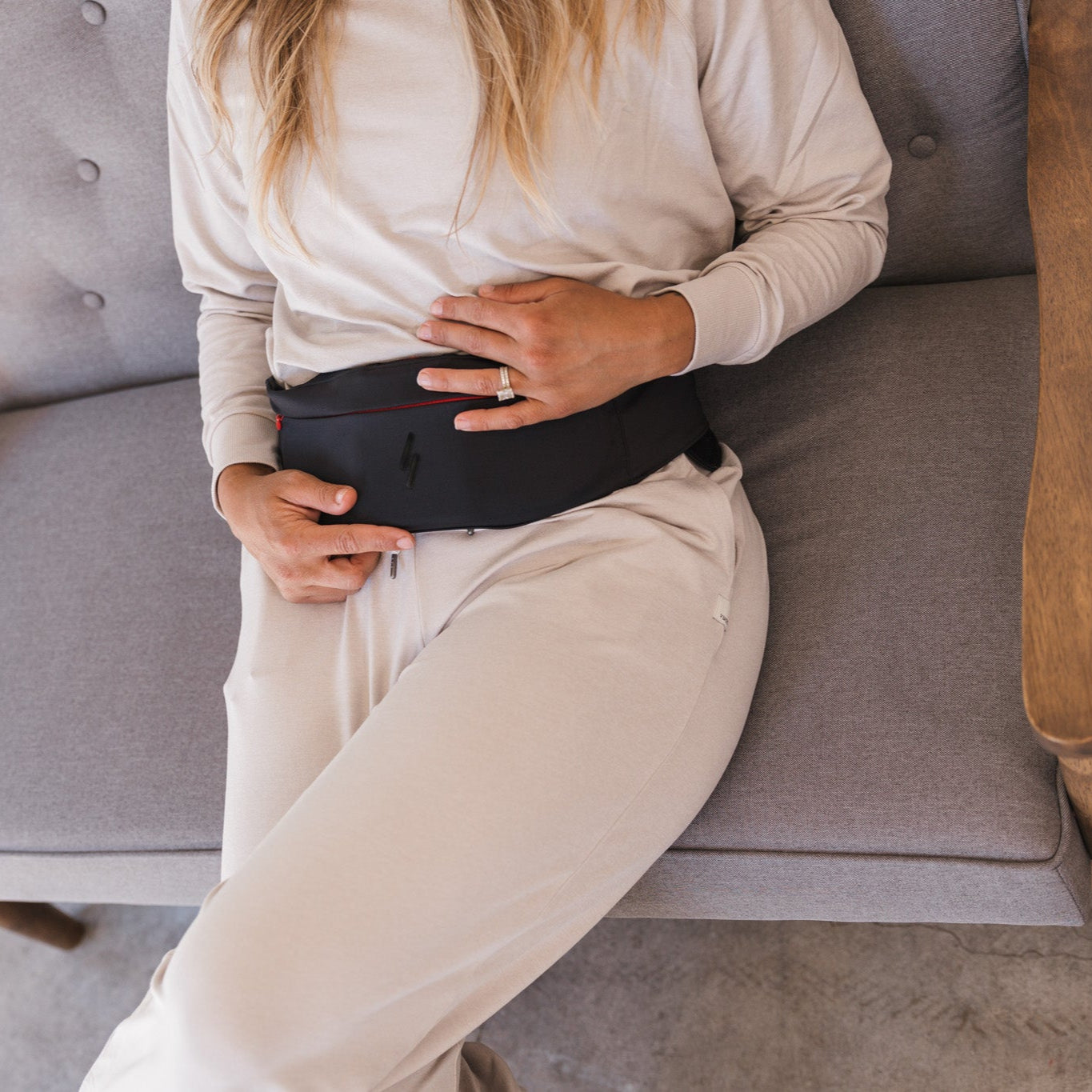 Person sitting on a chair wearing a black L1 belt